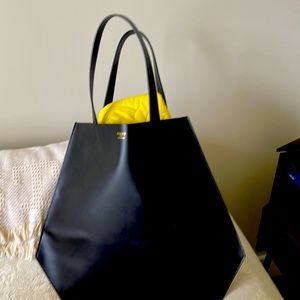Ports since 1961 has designed leather tote bags and high fashion bags/ purses